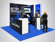 SemiCab exhibit booth with "Better Crystals" graphics on blue carpet